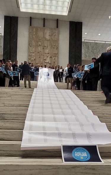 PEF leaders unfurl 42-foot-long petition at the Capitol, urging leaders to Fund Our Future 