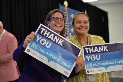 PEF members with signs thanking the governor for negotiating with the union to include Paid Parental Leave in the tentative contract.