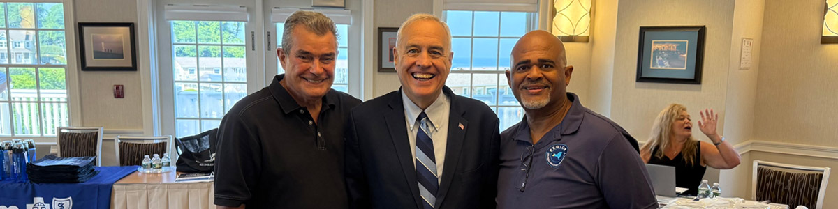 President Spence, right, was congratulated by NYSPEC Chairman Peter Meringilo, left, and NYS Comptroller Tom DiNapoli, July 29 on Long Island.